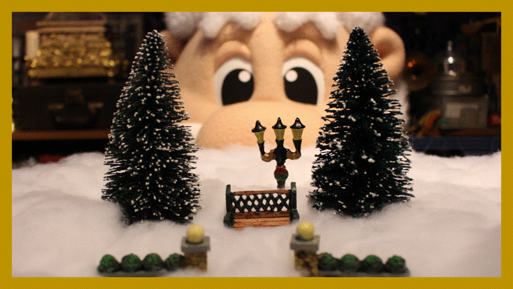 Pepperoni, a cartoon wizard, looking through a miniature winter scene.